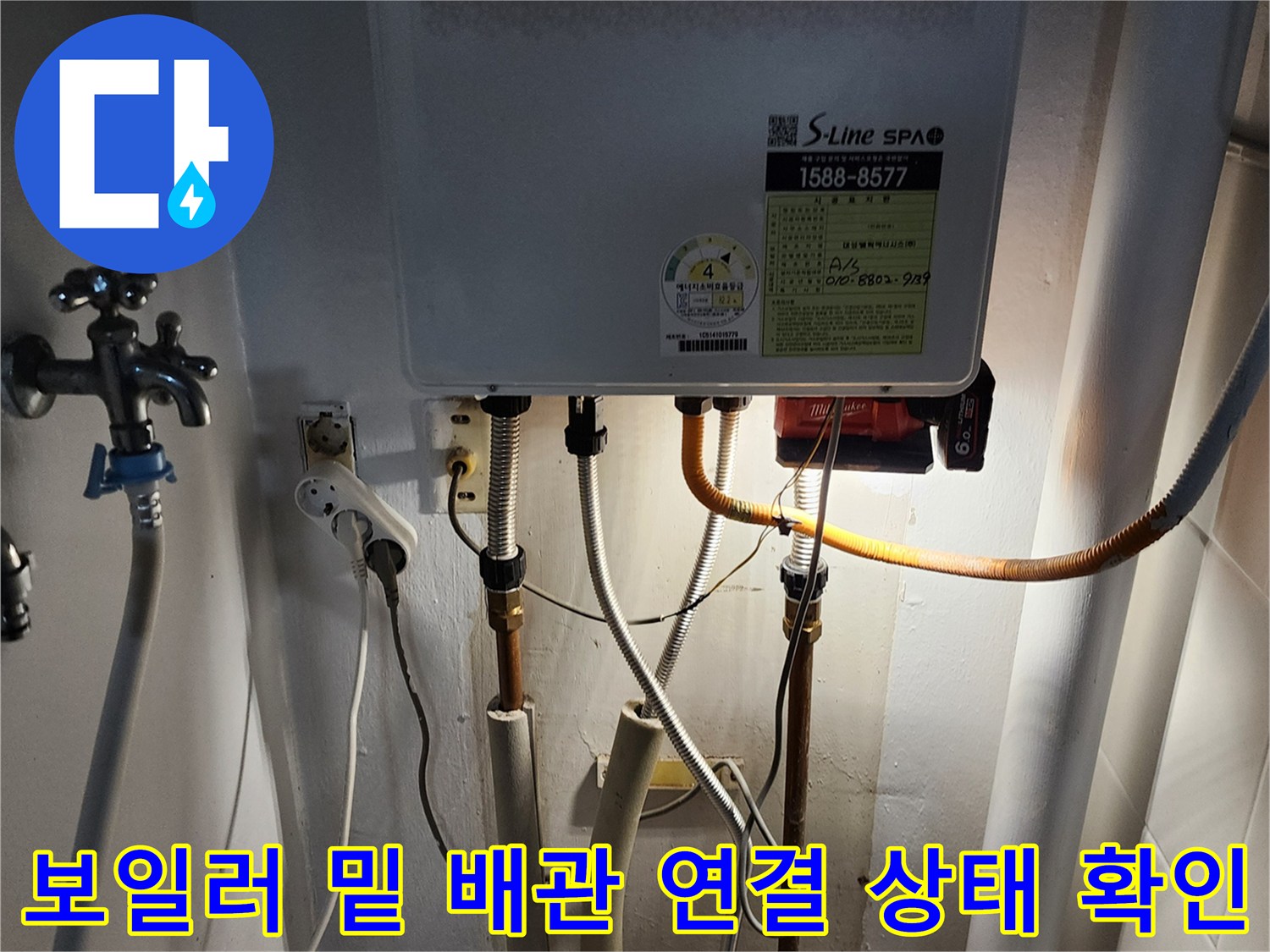 보일러-하단부에-연결된-다양한-종류의-배관과-전선들