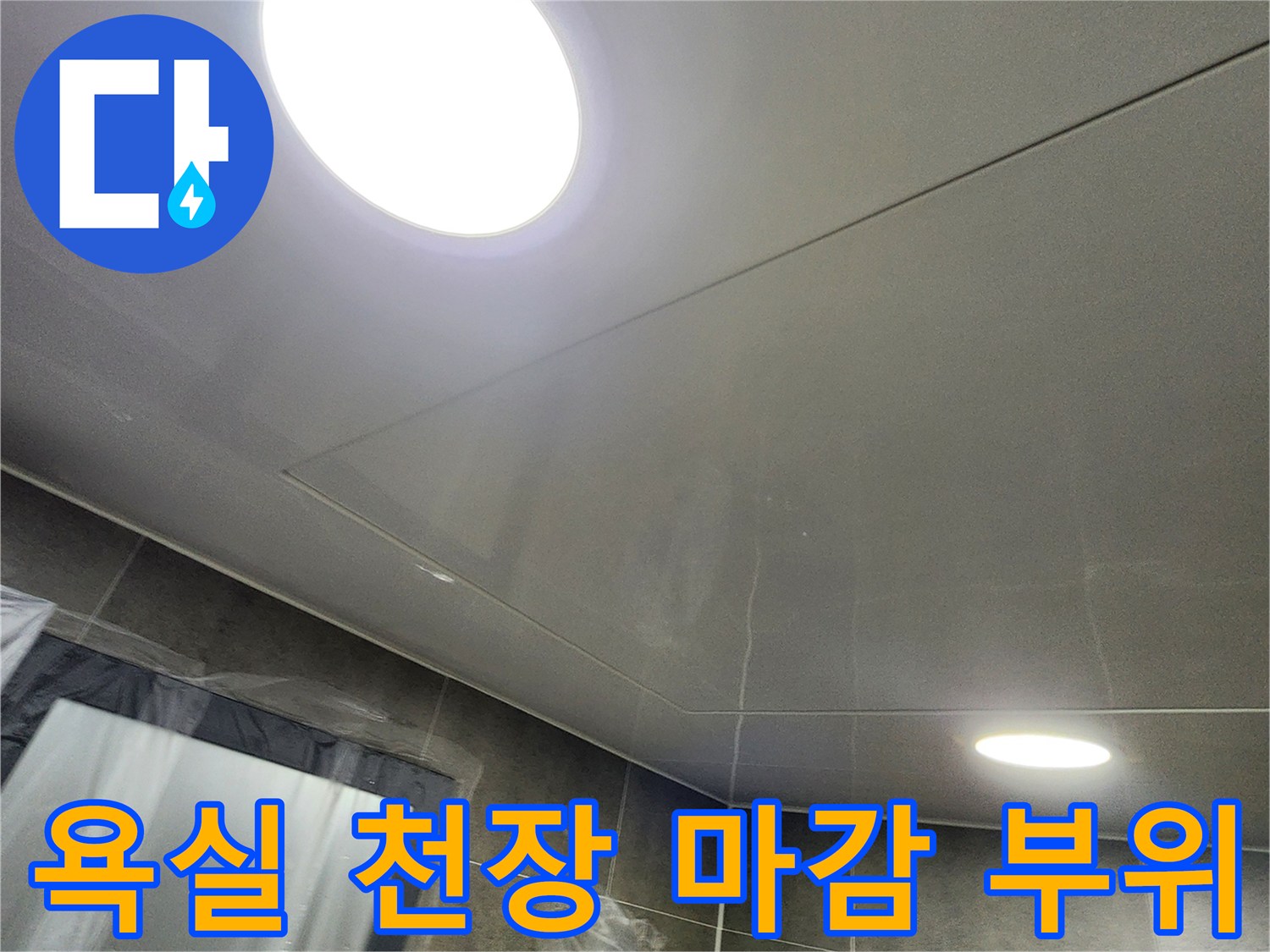 매끄러운 질감의 욕실 천장재와 설치된 조명