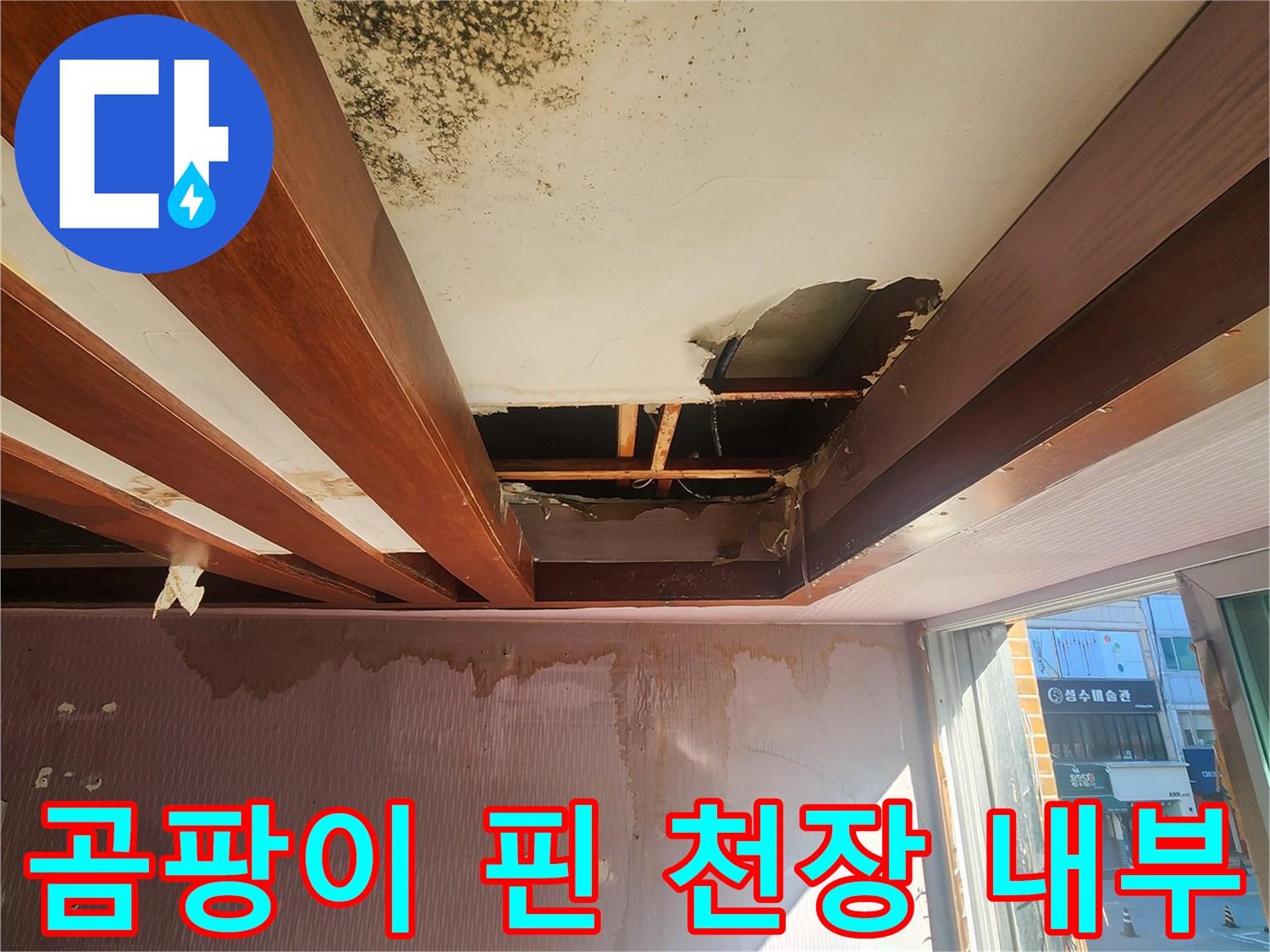 심각하게 오염된 천장 마감재와 노출된 목재 구조물