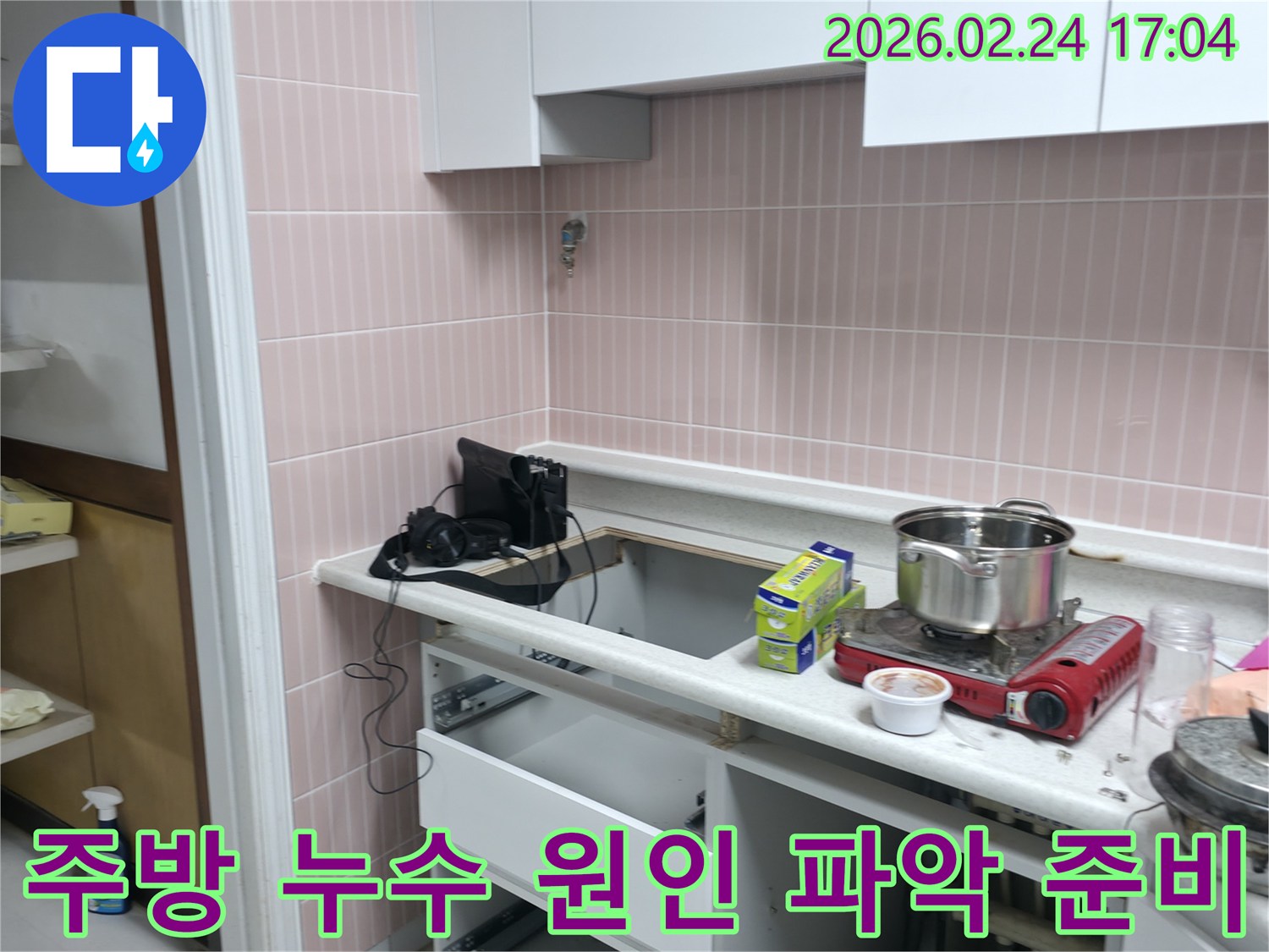 아파트 주방에서 발생한 누수의-정확한 원인을-찾기 위해-작업을 준비하는 모습입니다.