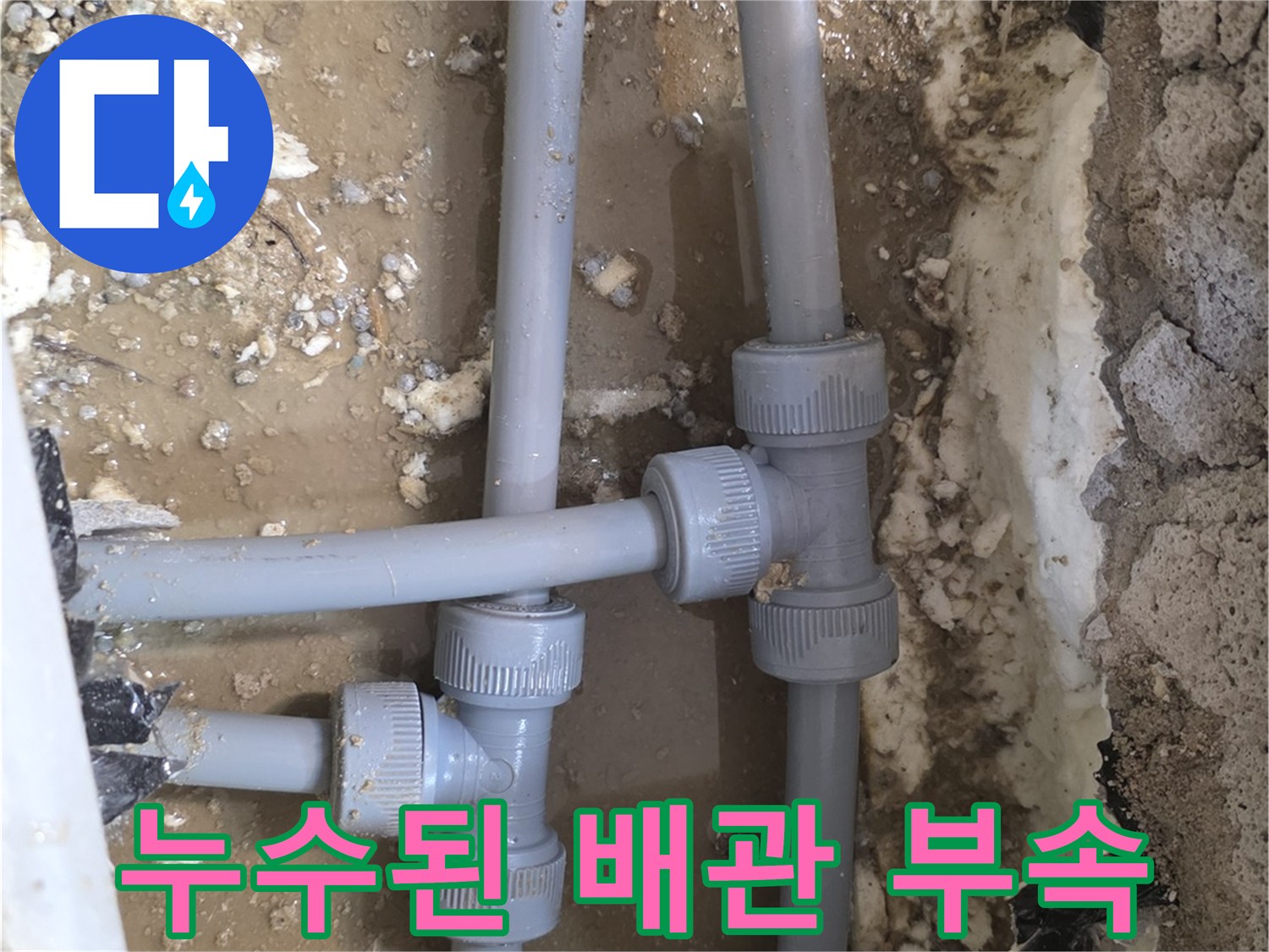 손상된 회색 배관의 T자형 연결 부위 노출 상태