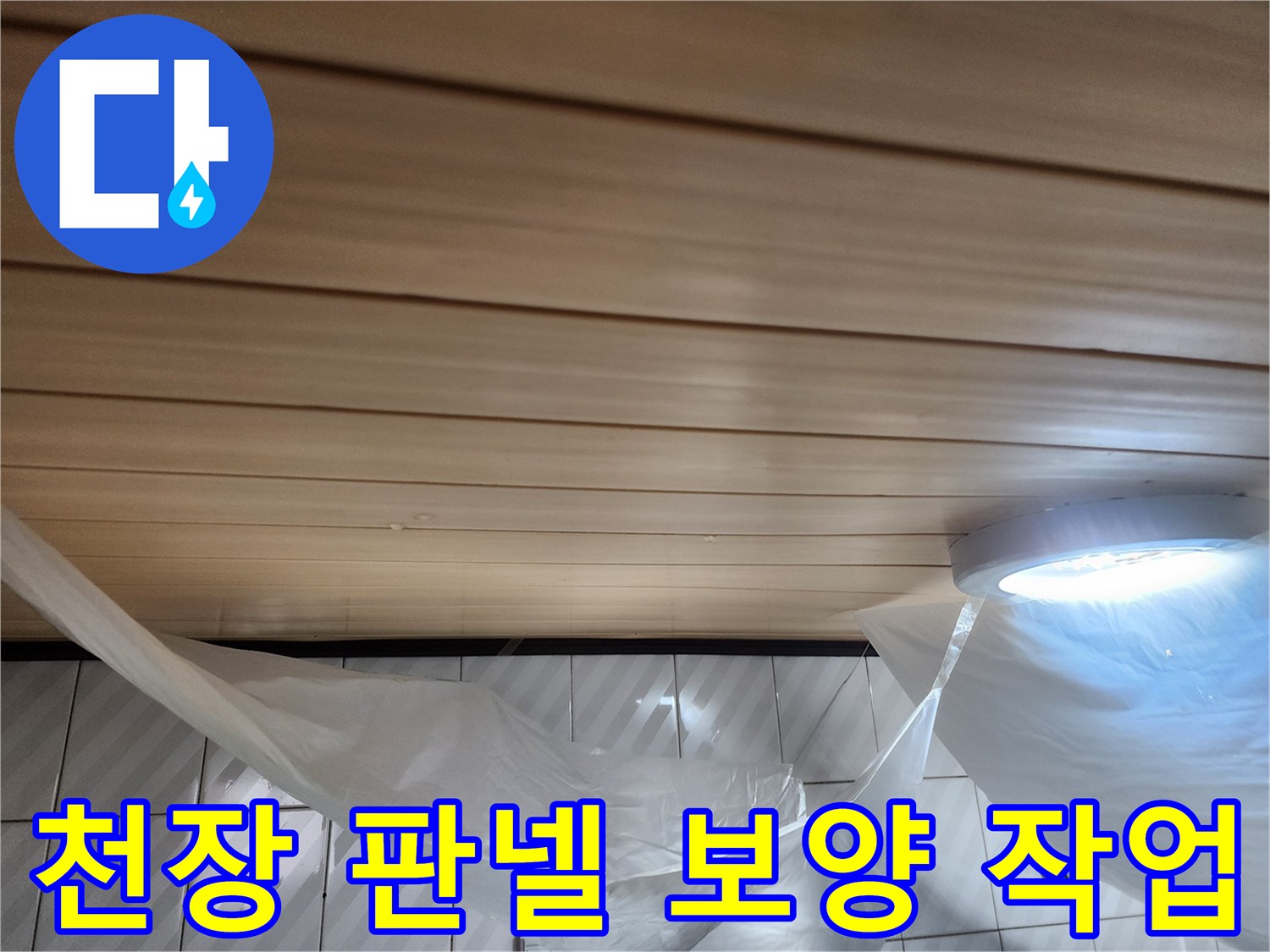 비닐로 덮여 있는 화장실 천장 마감재와 조명 기구