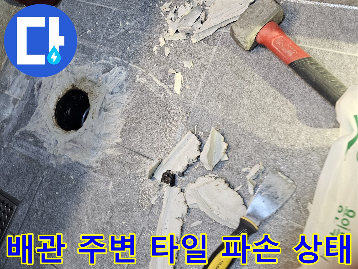 변기를 들어낸 후 드러난 오수관과 깨진 타일 조각들