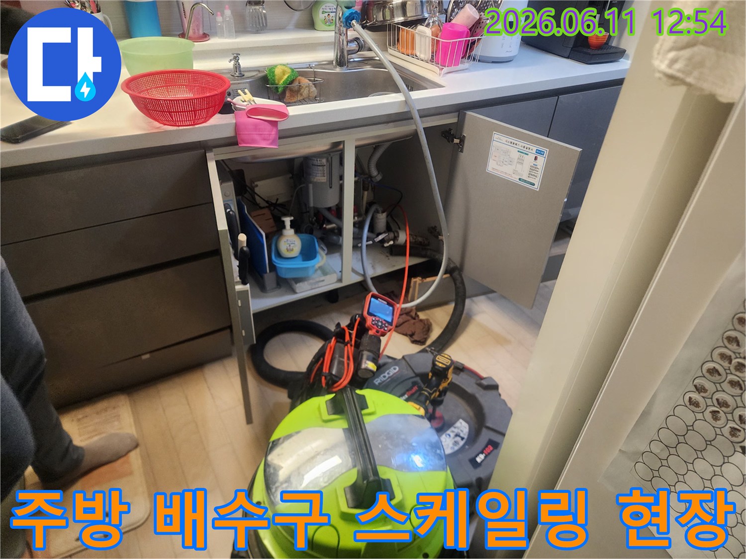 싱크대 하단 작업 공간 - 석션기와 배관 청소 장비 세팅 완료