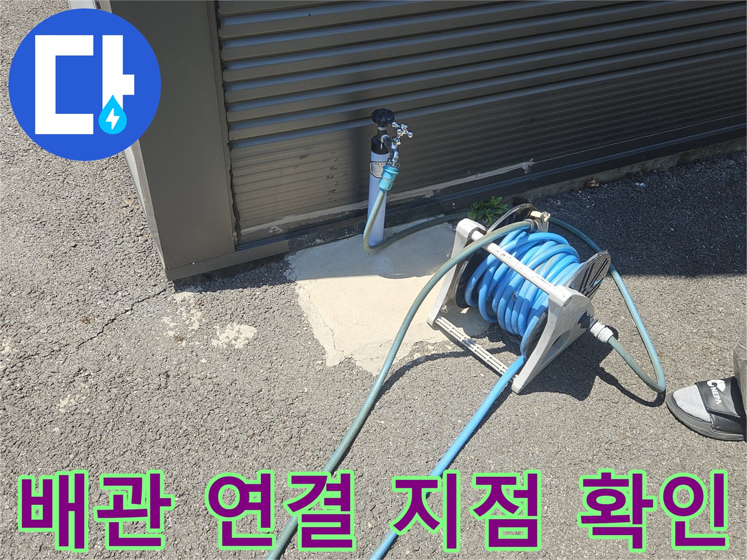 외부 벽면 배관과 작업용 호스 릴의 근접 촬영