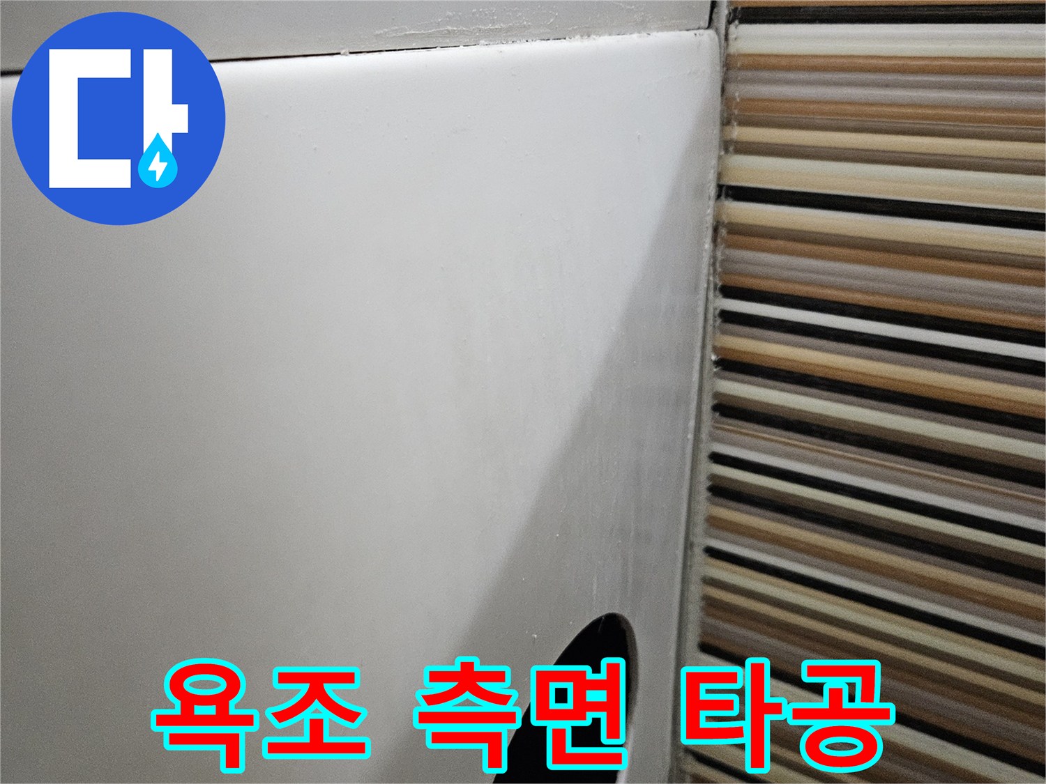 배관 수선을 위해 욕조 옆면을 둥글게 절개한 사진입니다.