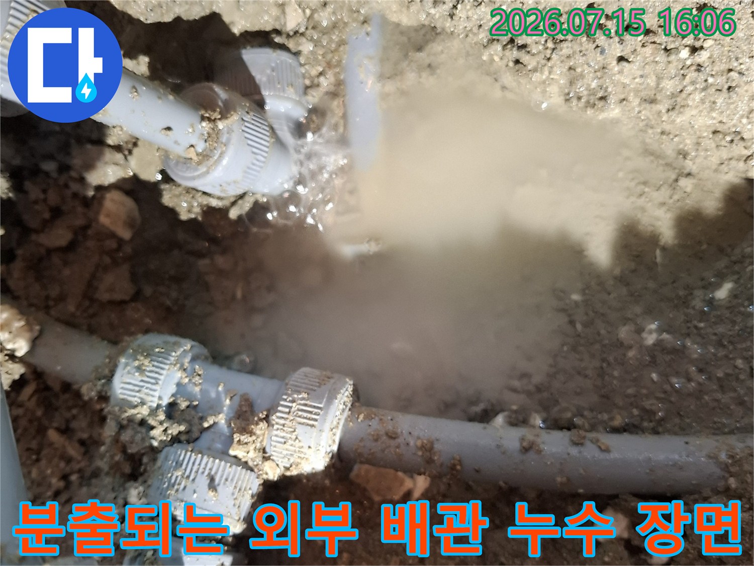 회색 플라스틱 수도 배관의 연결 부속에서 다량의 물이 뿜어져 나오는 사진