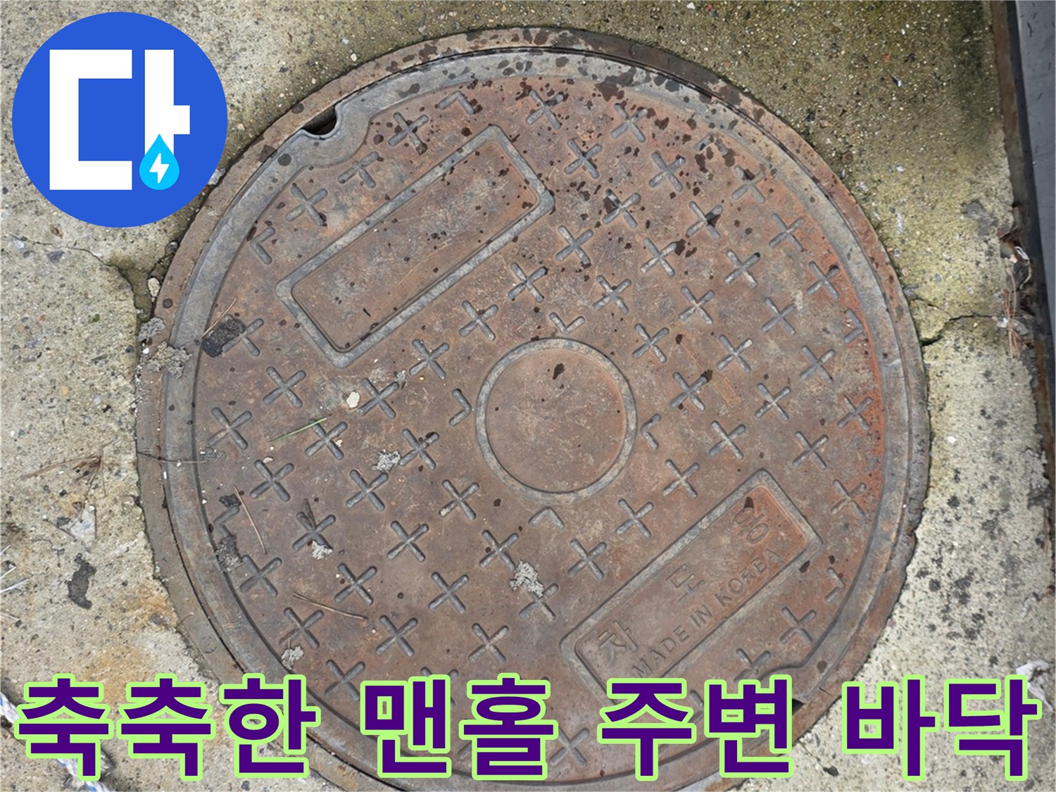 물기가 배어 나온 맨홀 근처 지면