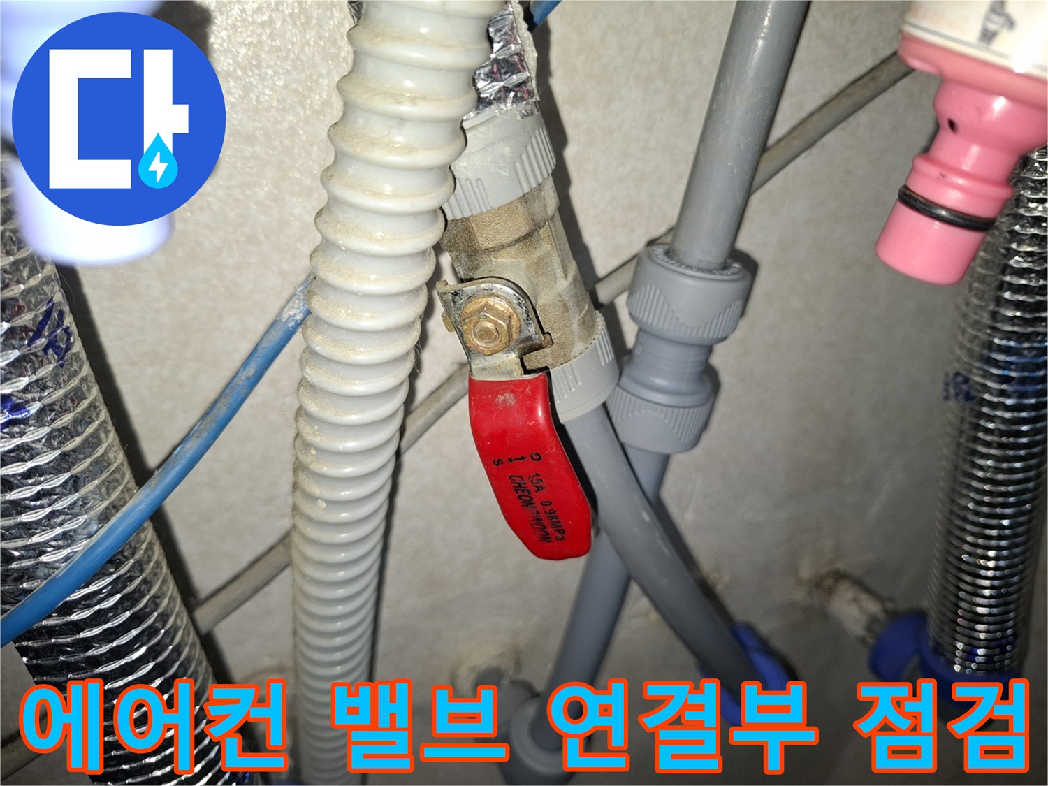 빨간색 핸들 밸브와 회색 배관의 누수 지점