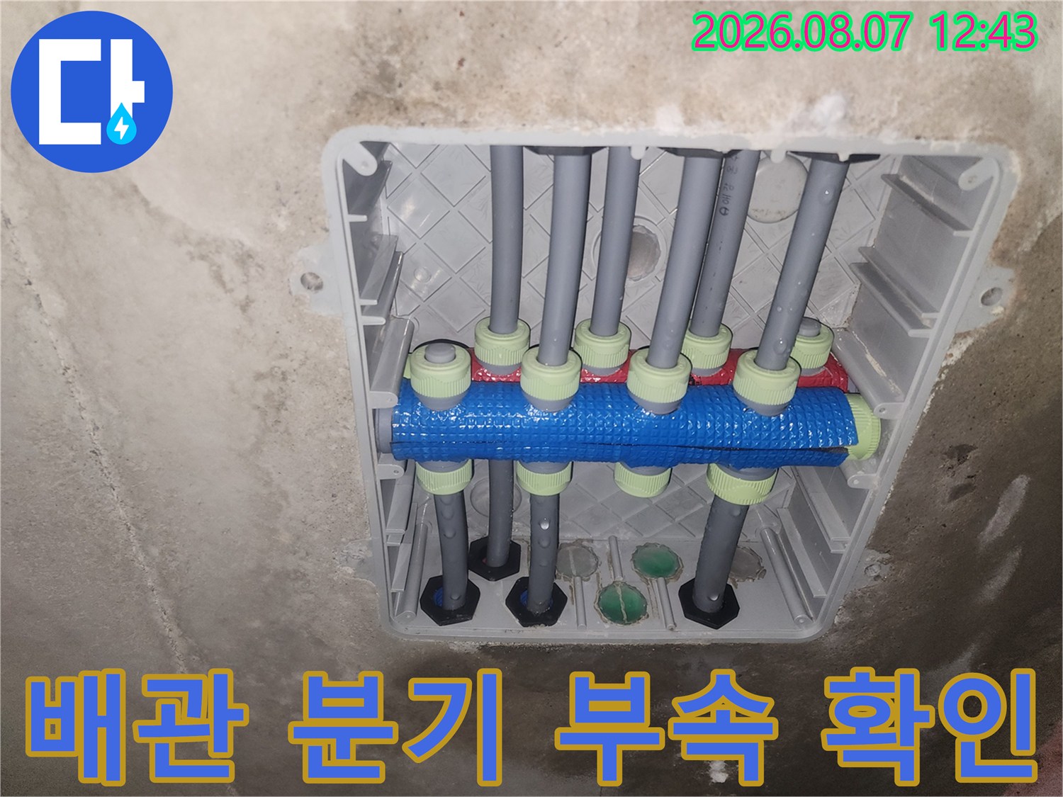 파란색 분기 부속에-연결된 여러 개의 회색 배관들
