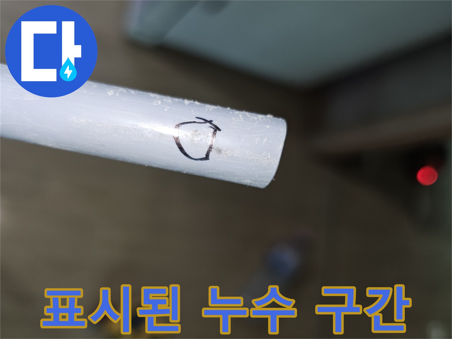 흰색 배관 위에 검은 펜으로 표시된 누수 지점