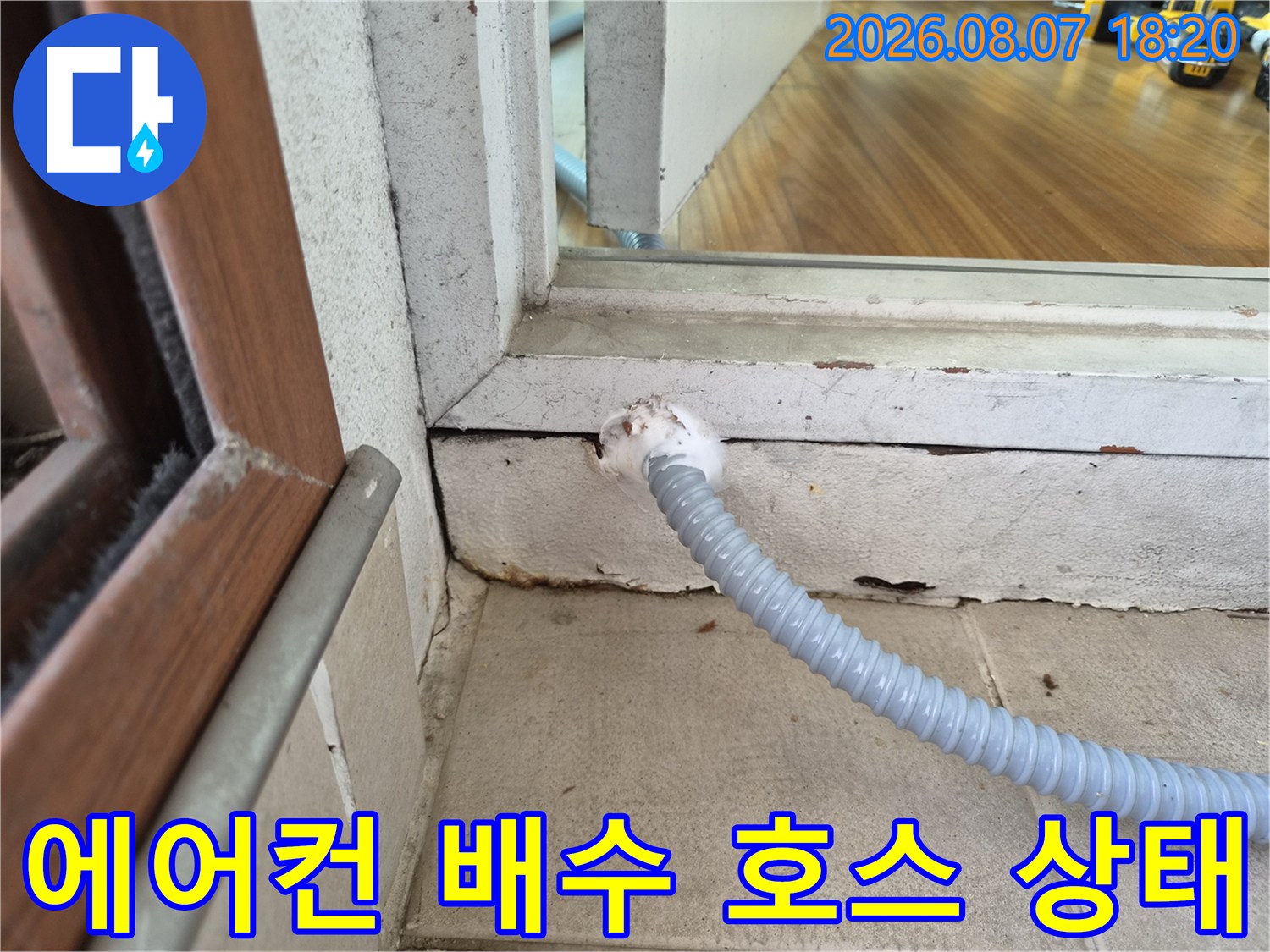 창틀 하단부의 에어nu수 드레인 호스 연결 부위 상세 사진입니다.