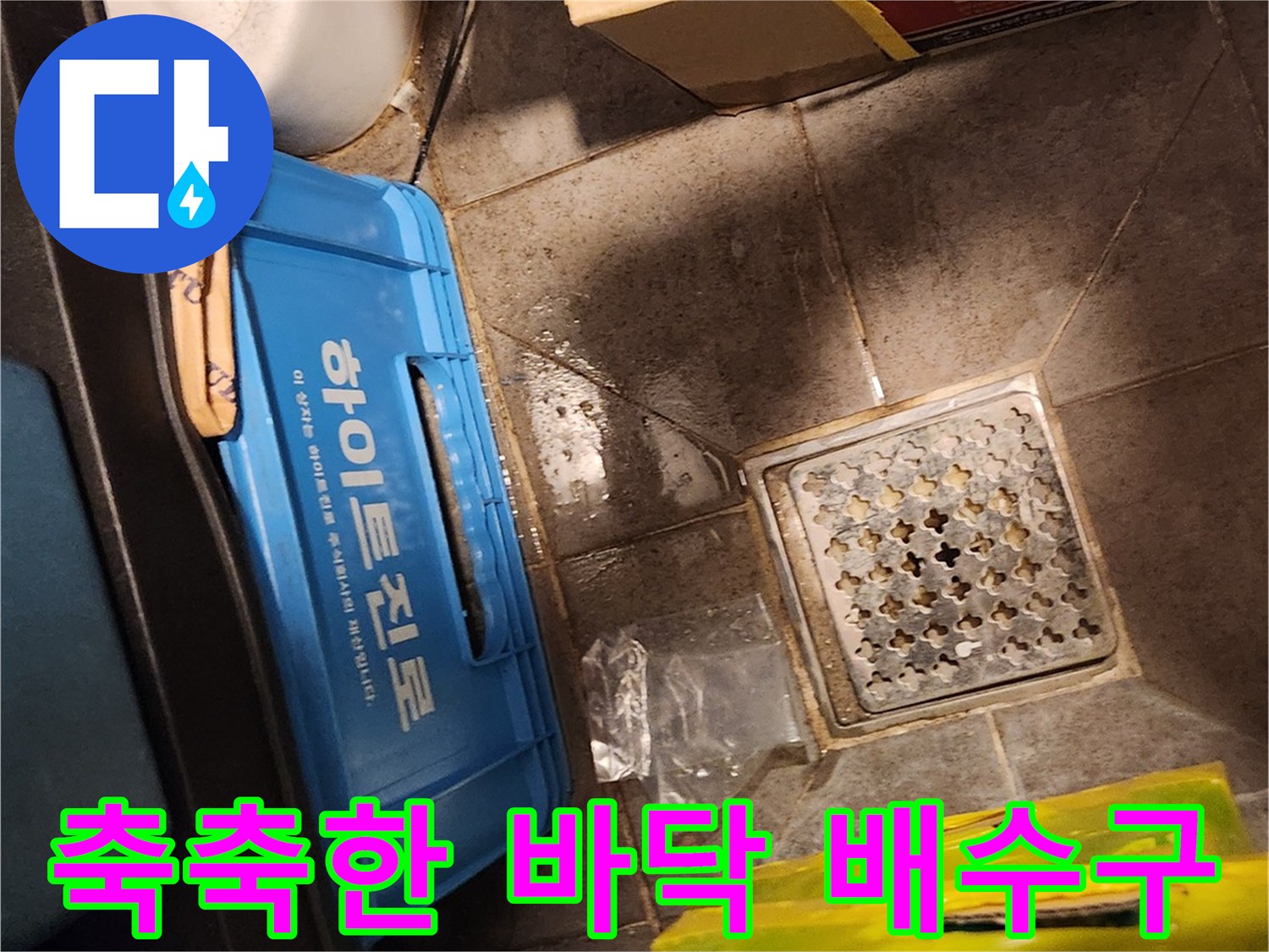 창고 내부 배수구 주변의 물기가 있는 타일 모습