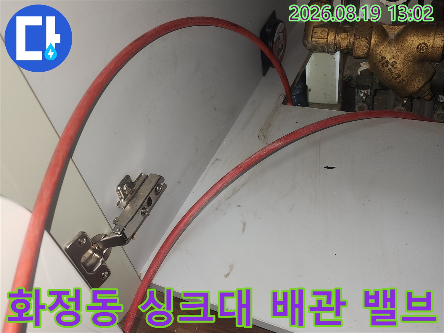 싱크대 하단 금색 수도 밸브와 연결된 배관들