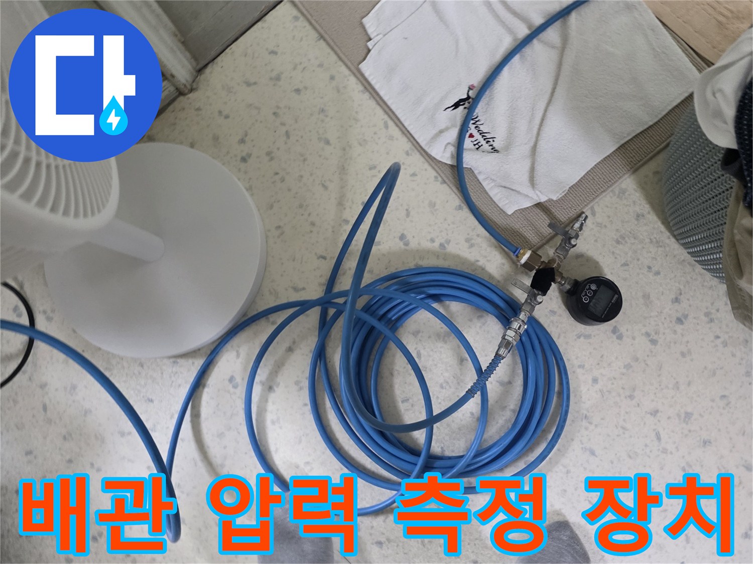 현장 작업 모습-압력 게이지와 파란색 배관 호스