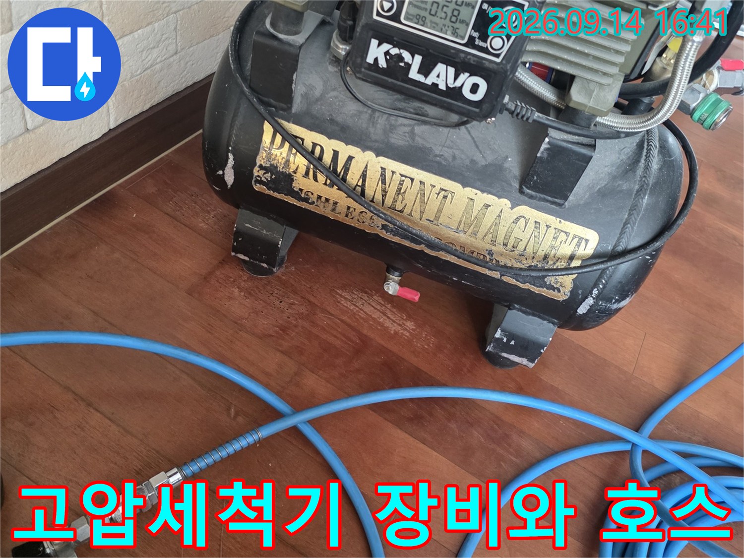현장에서 사용 중인 고압 세척기 장비와 파란색 호스 모습입니다.